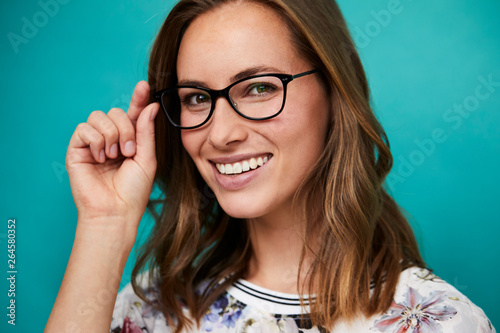 Smiling girl in glasses looking to camera