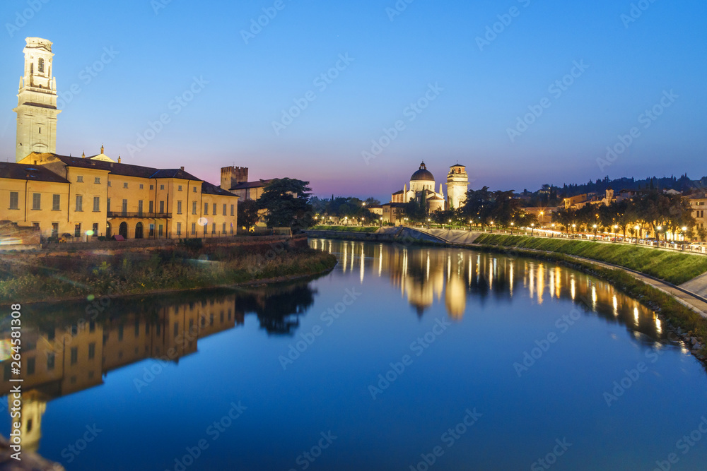 View from Ponte Pietra on Adige River and city at night. Verona. Italy