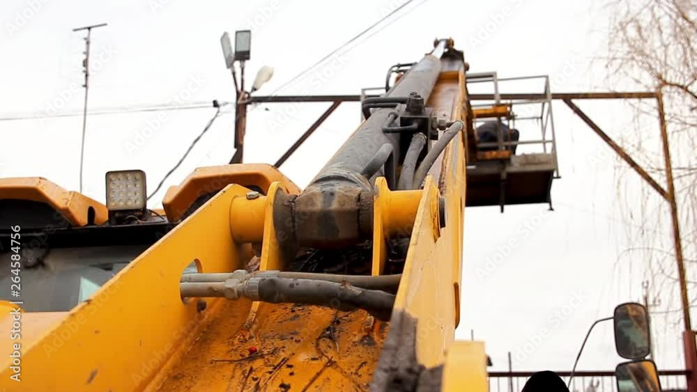 First-person view. Yellow crane lift. An electrician does his job repairing electrical wires. First-person view. Yellow crane lift. An electrician does his job repairing electrical wires.