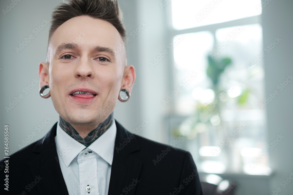 Portrait of alternative model with earplugs and tattoo Portrait of alternative model with earplugs and tattoo