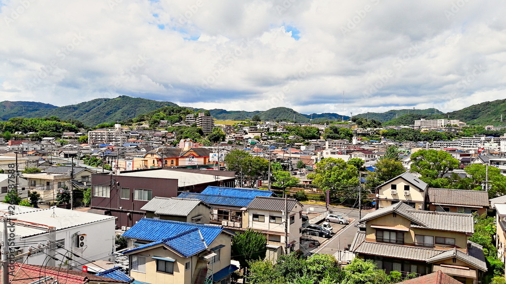 Fukuyama, Japan - August 29, 2016: Aerial view of the city of Fukuyama in a summer afternoon with hills on the background