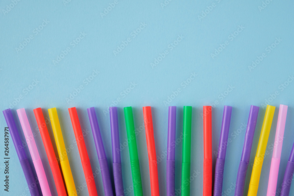 Fototapeta premium Multicolored Tubules for a cocktail on a blue background.