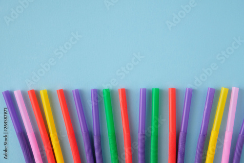 Multicolored Tubules for a cocktail on a blue background.