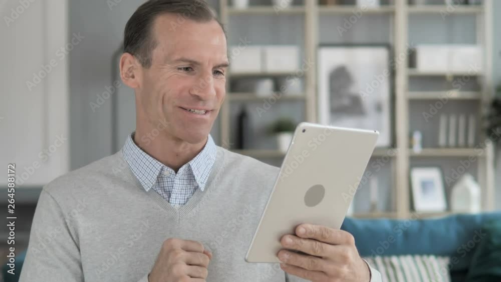 Online Video Chat on Tablet by Middle Aged Man Online Video Chat on Tablet by Middle Aged Man