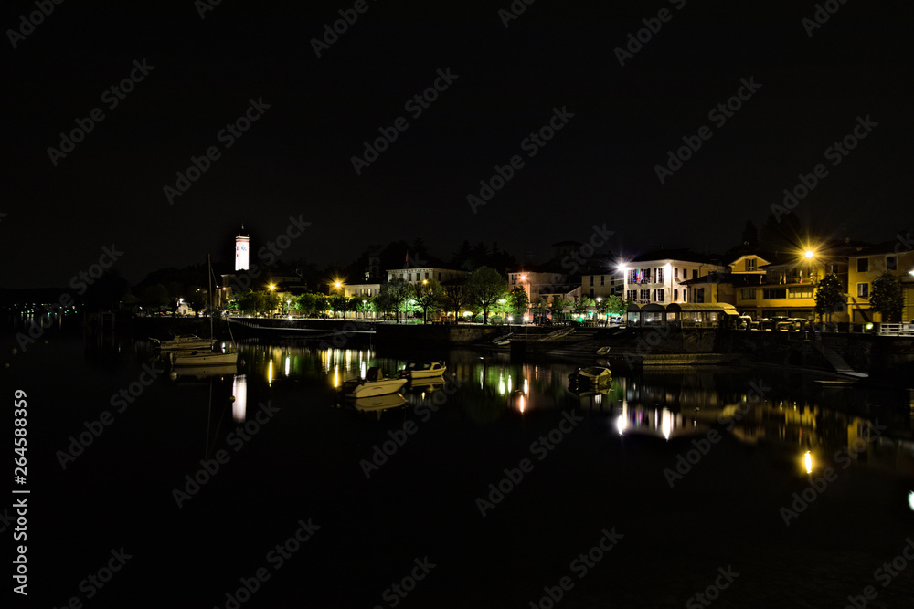Night view of the village of Lesa overlooking Lake Maggiore, Piedmont, Italy