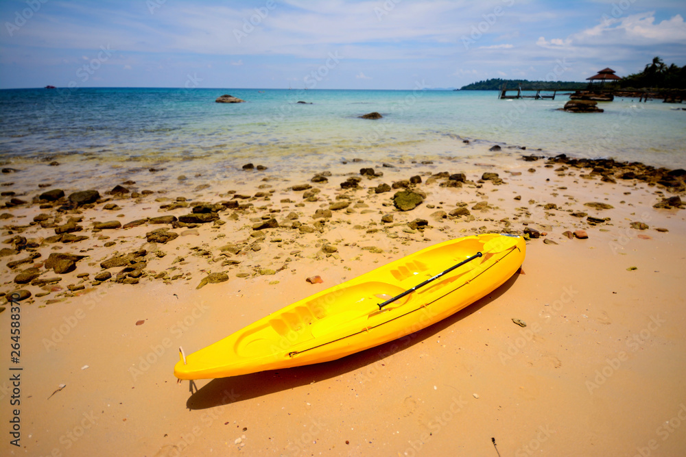   A bright yellow kayak on the beach