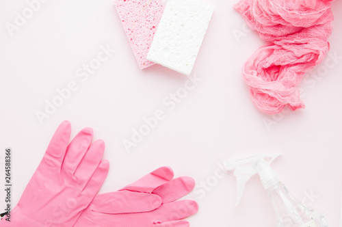 spring cleaning supplies on a pink background with copy space © sianc