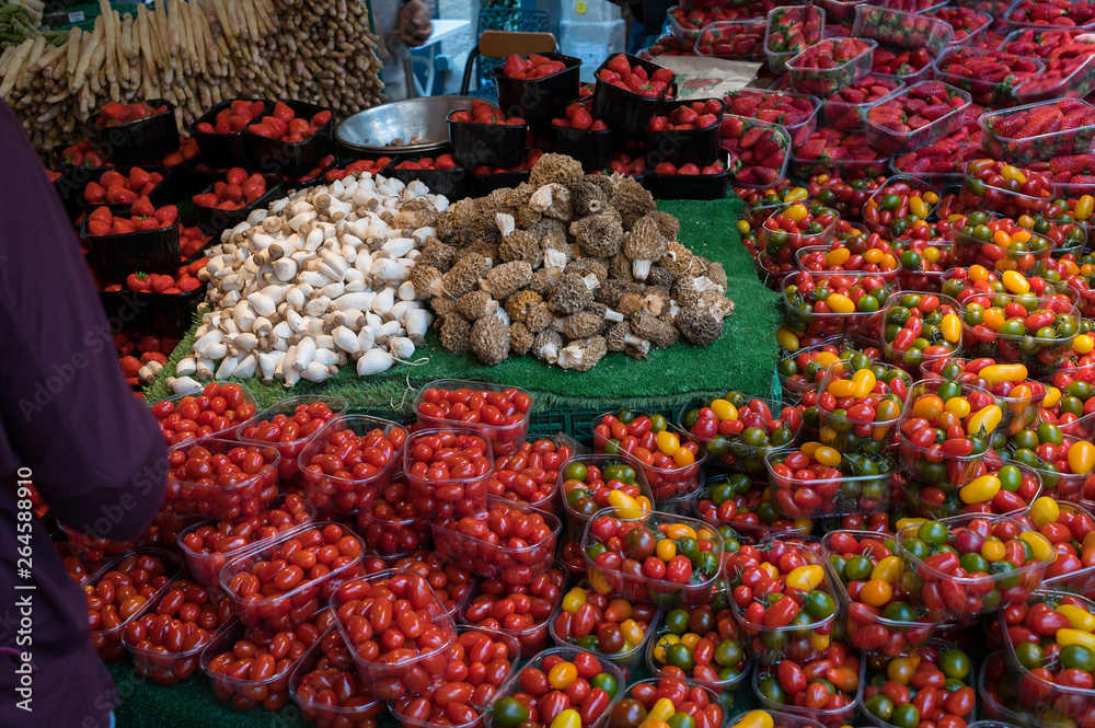 Cherry tomatoes and fungi on sale  in Paris' Marche d'Aligre market
