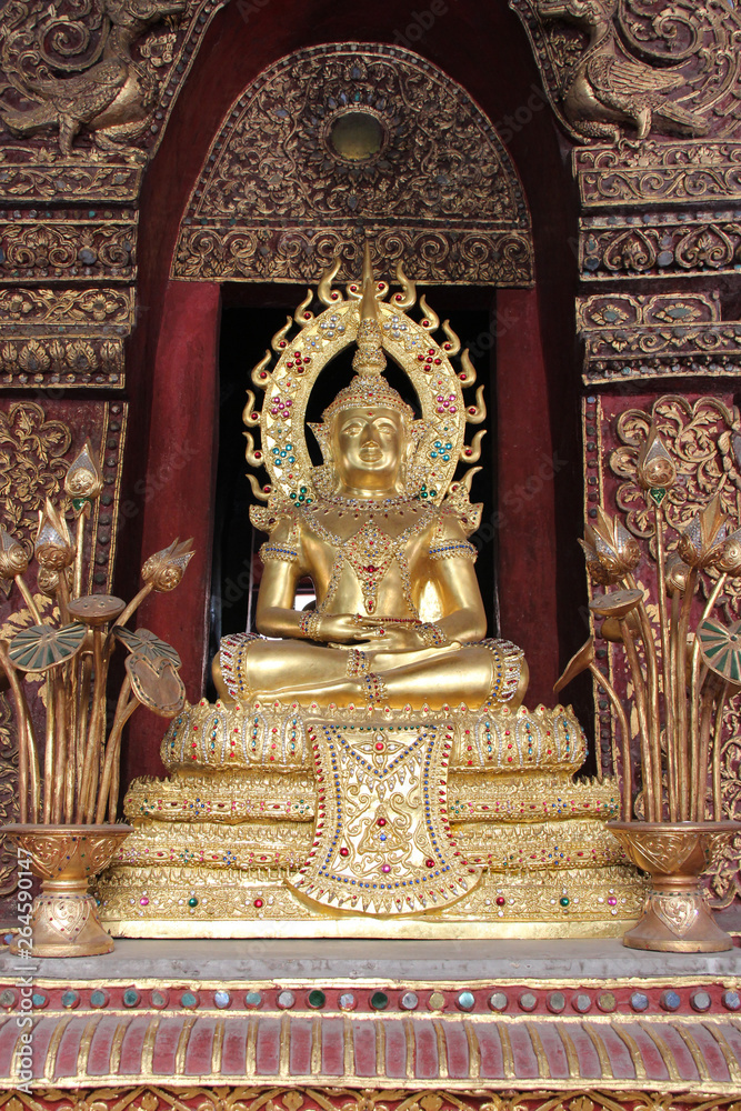 statue of buddha in a buddhist temple (wat phra sing) in chiang mai (thailand)