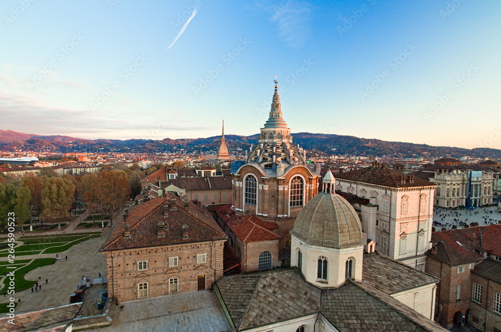 View from the bell tower of the Cathedral, towards the Dome of the Chapel that houses the Holy Shroud, and the Mole Antonelliana, background of hills, seen at sunset, Turin, Piedmont, Italy