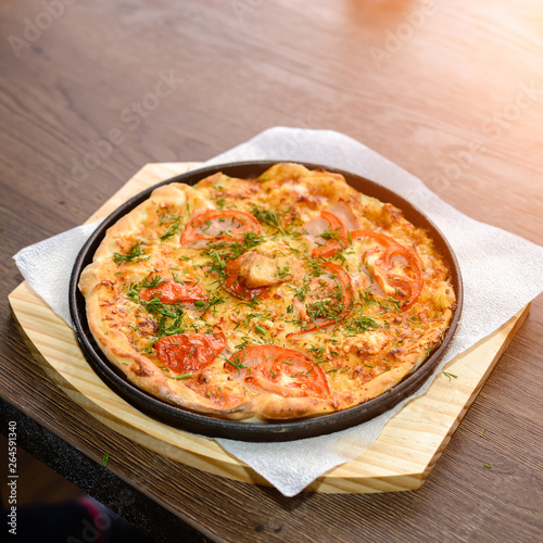 fast food, italian kitchen and eating concept - close up of homemade pizza on wooden table