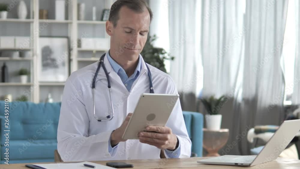 Senior Doctor Using Tablet for Online information Senior Doctor Using Tablet for Online information