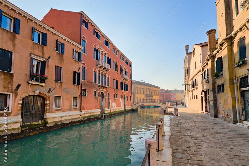 Typical view of the old city of Venice, Italy, with canals, bridges, ancient buildings immersed in water, boats and gondolas