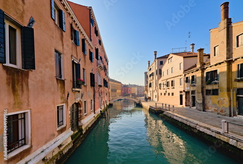 Typical view of the old city of Venice, Italy, with canals, bridges, ancient buildings immersed in water, boats and gondolas © Marco