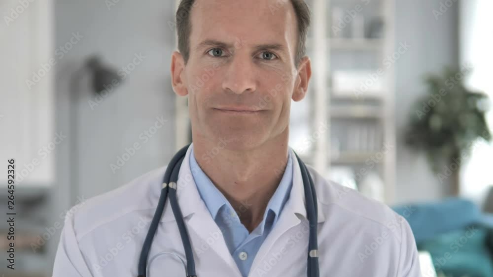 Senior Doctor in Clinic Looking at Camera Senior Doctor in Clinic Looking at Camera
