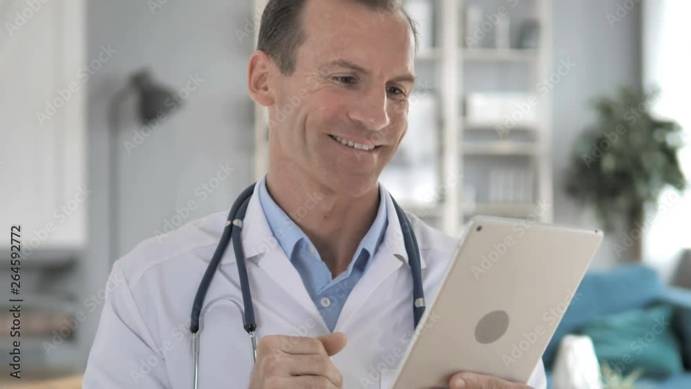 Senior Doctor Discussing with Patient via Video Chat on Tablet Senior Doctor Discussing with Patient via Video Chat on Tablet