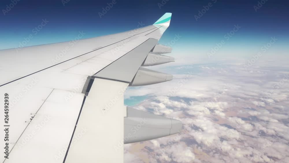 A view above africa through an airplane window showing a wing, a desert landscape and the mediterranean sea A view above africa through an airplane window showing a wing, a desert landscape and the mediterranean sea