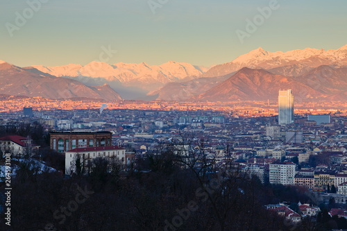 Aerial view of Turin, Italy, at sunrise, with the city center and the Mole Antonelliana, sun is giving its first light on the city