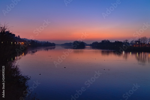 Romantic purple sunset on the Po river in San Mauro Torinese, near Turin, Piedmont, Italy