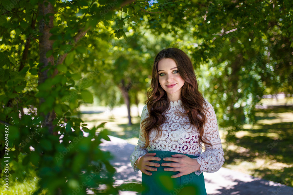 young pregnant woman walking in the park young pregnant woman walking in the park