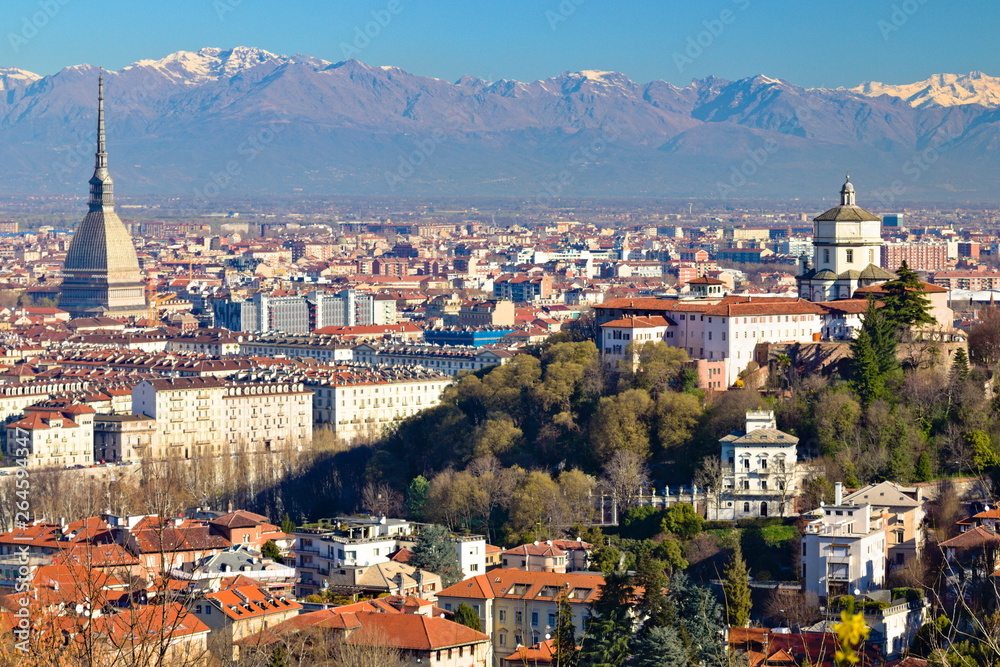 Aerial view on Monte dei Cappuccini, Mole Antonelliana and Turin city center from a nearby hill in a clear spring morning, with alps on background, Piedmont, Italy