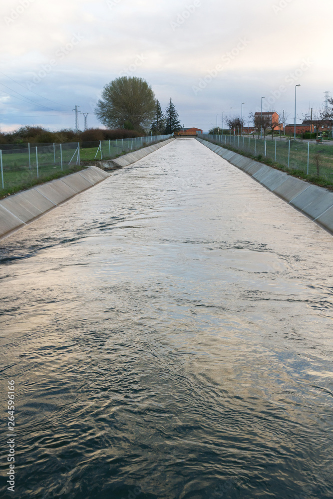 Canalizacion de agua para el riego y salto de agua para producción de  electricidad Stock Photo | Adobe Stock