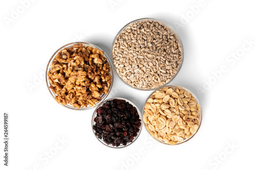 Sunflower seeds, salted peanut, walnut and raisins isolated on white background.
