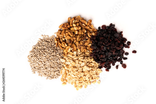 Sunflower seeds, salted peanut, walnut and raisins isolated on white background. © Natallia