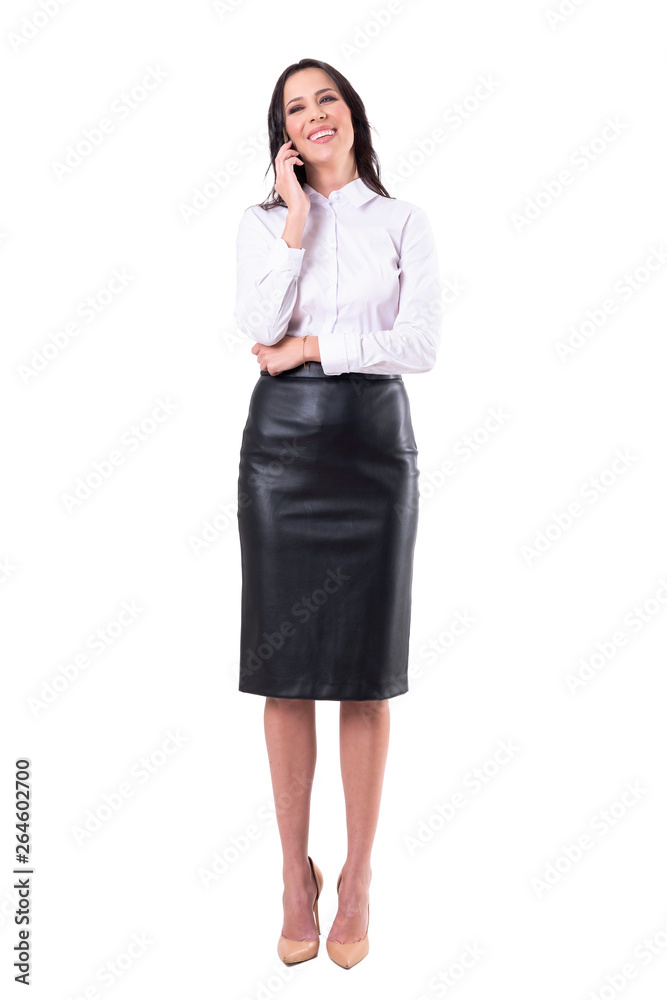 Cheerful relaxed carefree young business woman laughing on the mobile phone. Full body isolated on white background. Cheerful relaxed carefree young business woman laughing on the mobile phone. Full body isolated on white background.
