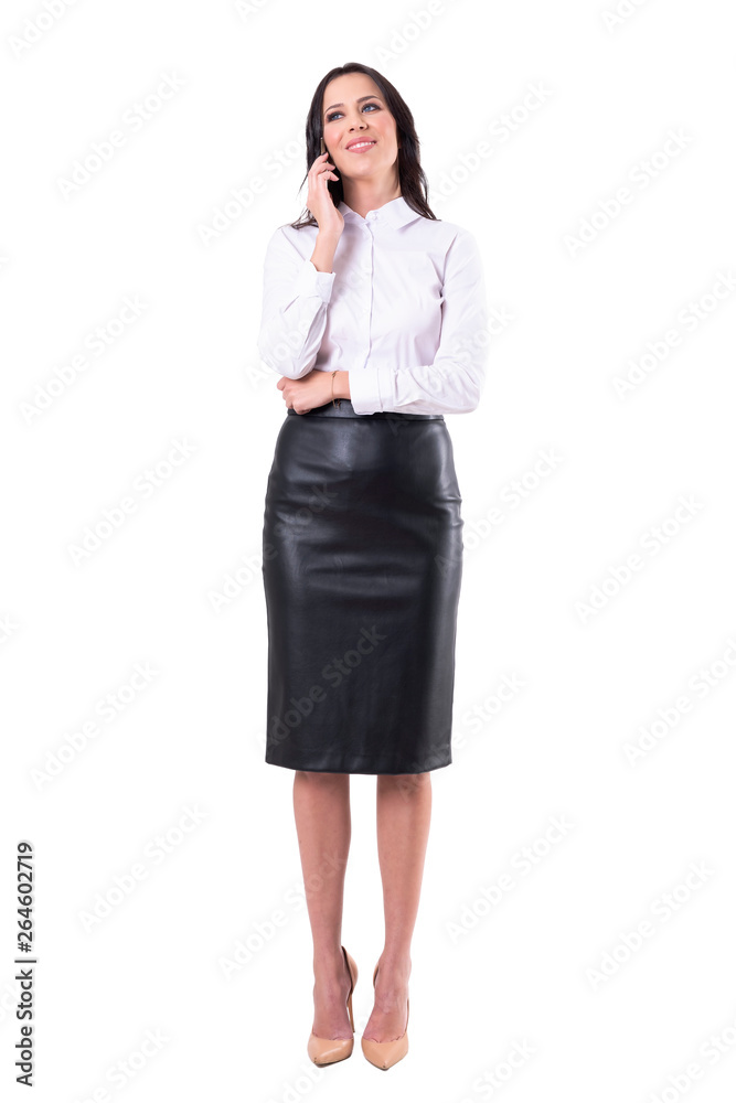 Confident happy young attractive business woman talking on the phone smiling and looking away. Full body isolated on white background. Confident happy young attractive business woman talking on the phone smiling and looking away. Full body isolated on white background.