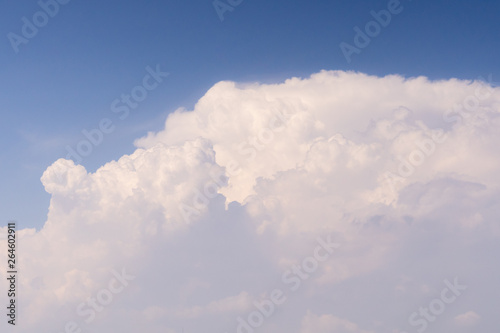 soft white fluffy cloud on bright clear blue sky with copy space