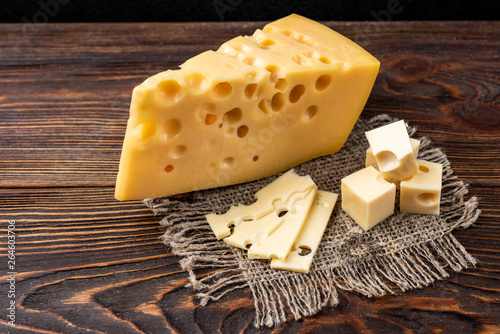 Cheese on dark wooden background. 