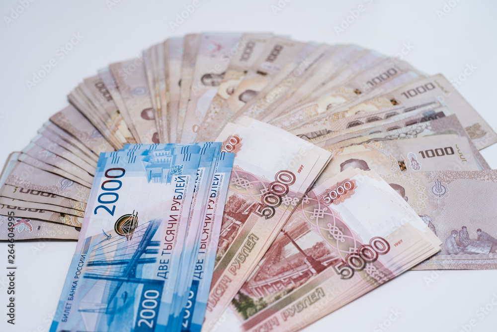 Russian rubles and Thai baht close-up. Ruble-butt rate Russian rubles and Thai baht close-up. Ruble-butt rate