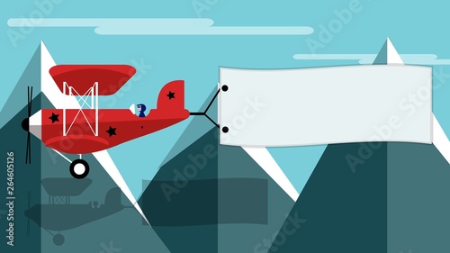 Airplane with banner in front of a mountain backdrop