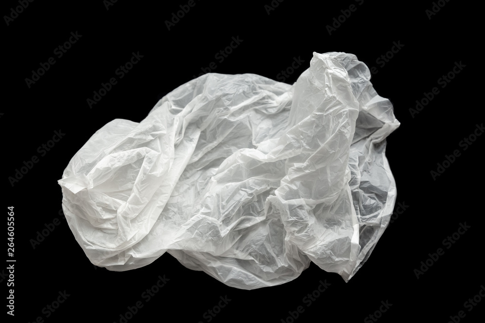 Fototapeta premium Plastic bag on a black background, isolate. Used plastic bag for recycling. Recycling of plastic waste into pellets as a business.