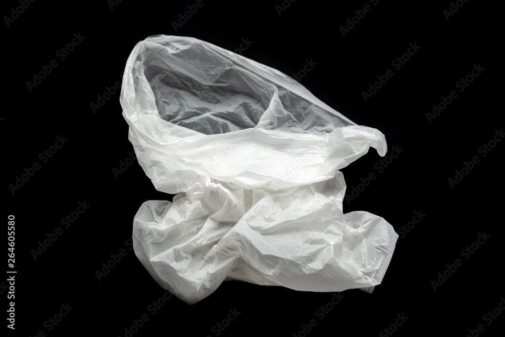 Plastic bag on a black background, isolate. Used plastic bag for recycling. Recycling of plastic waste into pellets as a business.