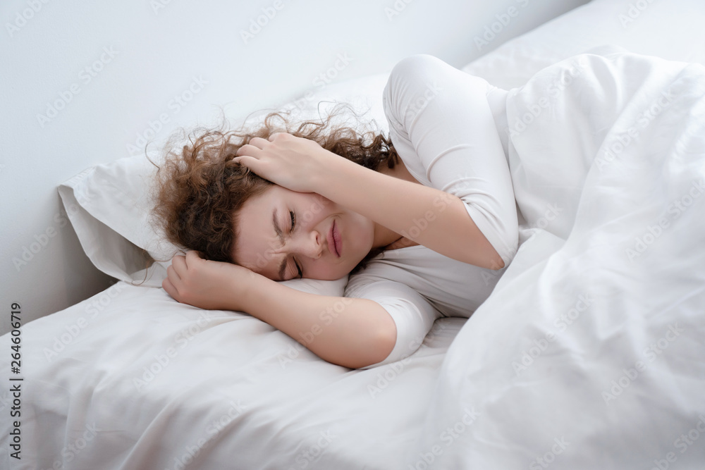 Caucasian Women wearing white pajamas lying in bed Insomnia caused by migraine discomfort. Accumulated stress And menstruation Relaxation that is not enough to weaken the body should consult doctor. Caucasian Women wearing white pajamas lying in bed Insomnia caused by migraine discomfort. Accumulated stress And menstruation Relaxation that is not enough to weaken the body should consult doctor.