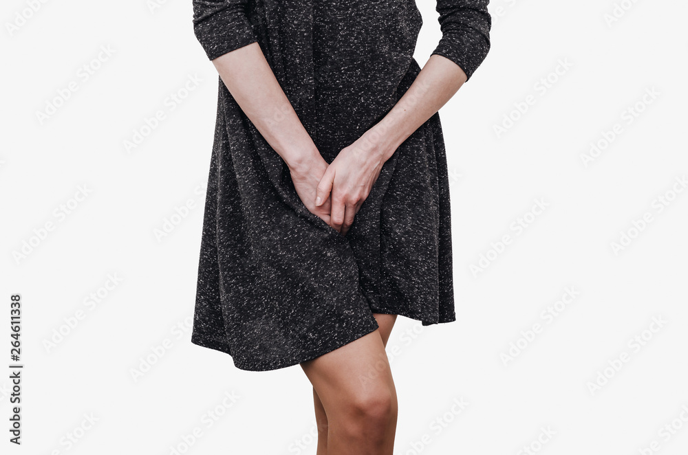 Slender girl in a dark dress experiences discomfort in the uterus, pain, hands between her legs. Incontinence, need to pee in the toilet Slender girl in a dark dress experiences discomfort in the uterus, pain, hands between her legs. Incontinence, need to pee in the toilet