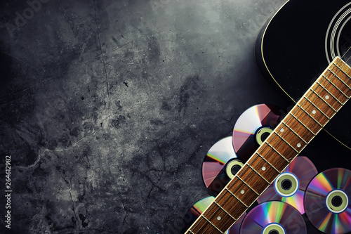 Guitar and accessories on a stone background. Desk musician, headphones, microphone. photo