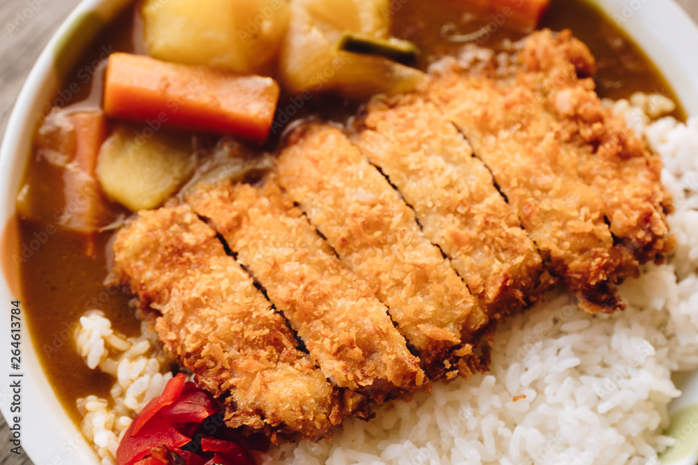 Rice with deep fried pork and curry in Japanese style or katsu kare in white plate ready to eat. Rice with deep fried pork and curry in Japanese style or katsu kare in white plate ready to eat.