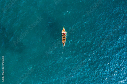 View from above, aerial view of a beautiful long tail boat sailing on a turquoise sea. Phi Phi Islands, Maya Bay, Krabi Province, Thailand.