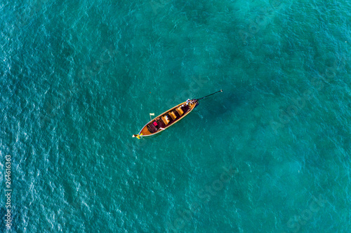 View from above, aerial view of a beautiful long tail boat sailing on a turquoise sea. Phi Phi Islands, Maya Bay, Krabi Province, Thailand. © Travel Wild
