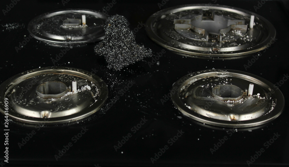 Cleaning gas stove with used kitchen cooking stuff, Housework or hygiene and cleaning concept Cleaning gas stove with used kitchen cooking stuff, Housework or hygiene and cleaning concept