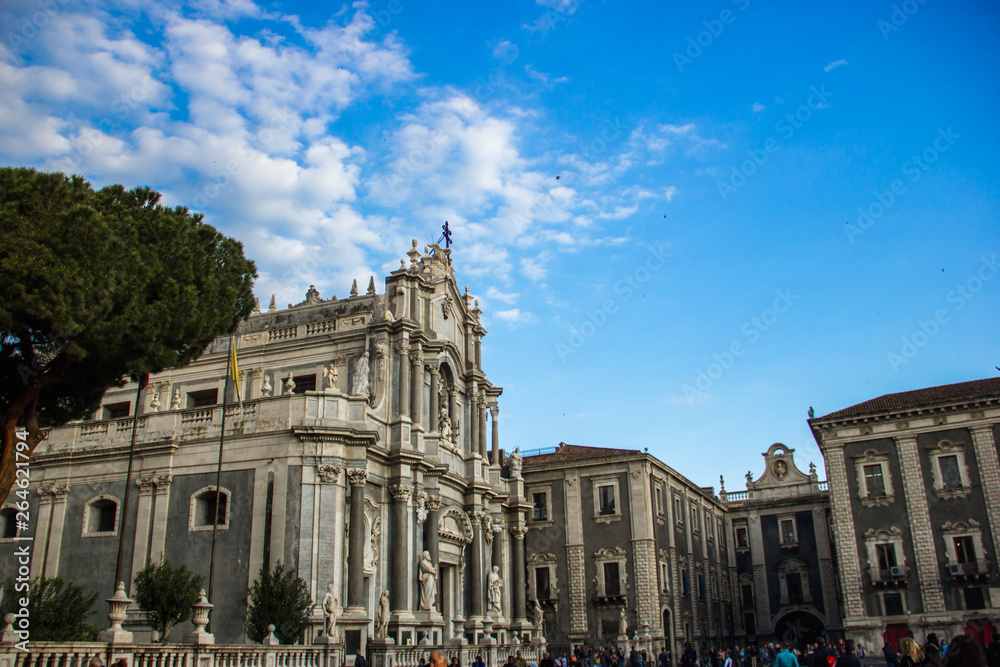 Catania cathedral square, distant side view church and baroque architecture building