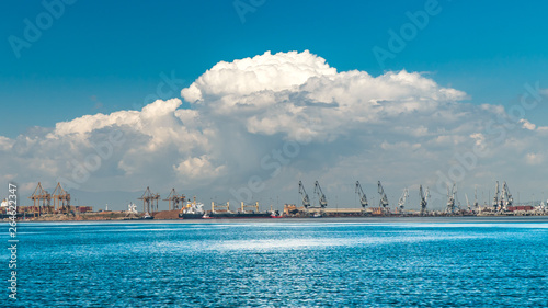 thessaloniki / Greece 11 April 2019 :heavy rain is approaching the city the port and the industrial area of the city ,beautiful thermaik gulf in sunny day