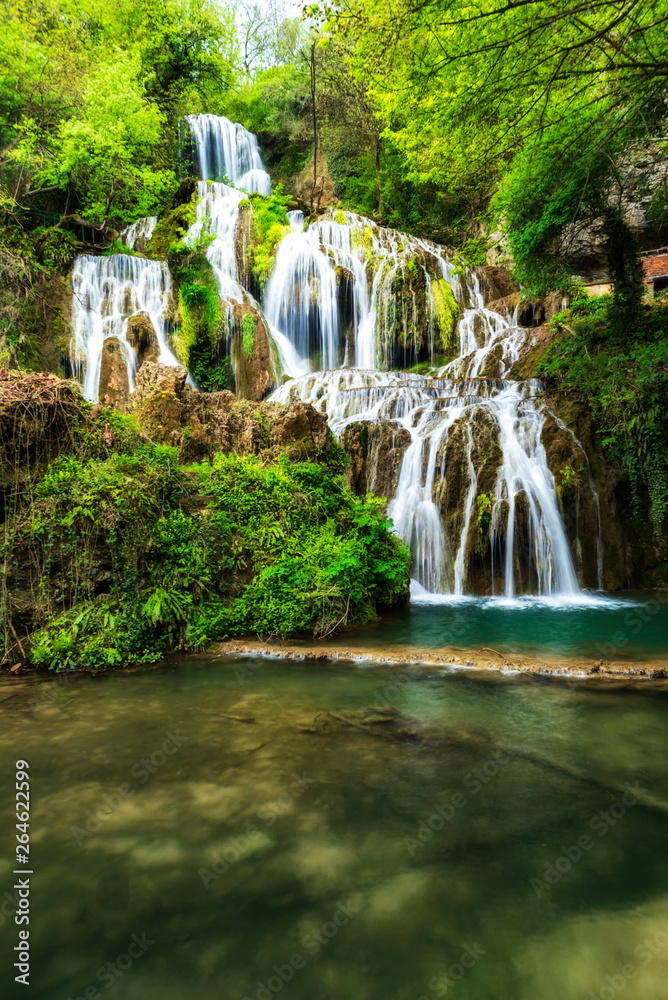 The turquoise water of Krushuna waterfalls terraces and pools - the biggest travertine cascade in Bulgaria The turquoise water of Krushuna waterfalls terraces and pools - the biggest travertine cascade in Bulgaria