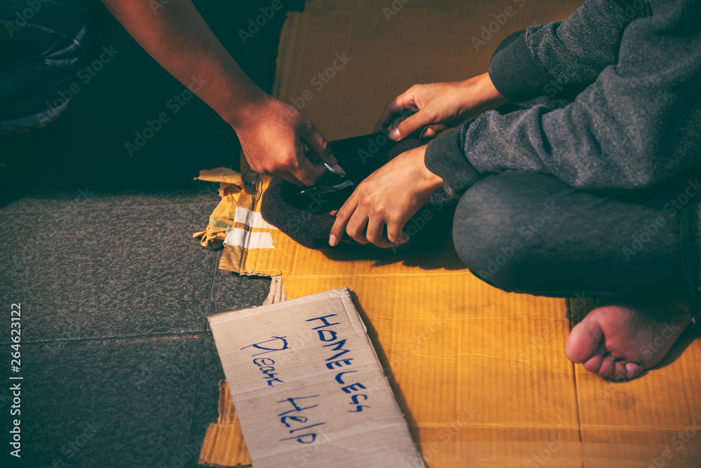 Obraz premium Beggars, Homeless people sitting on the floor, Discouraged and desperate, ask for a fraction of money from people travelng to buy food to live, to homeless concept.
