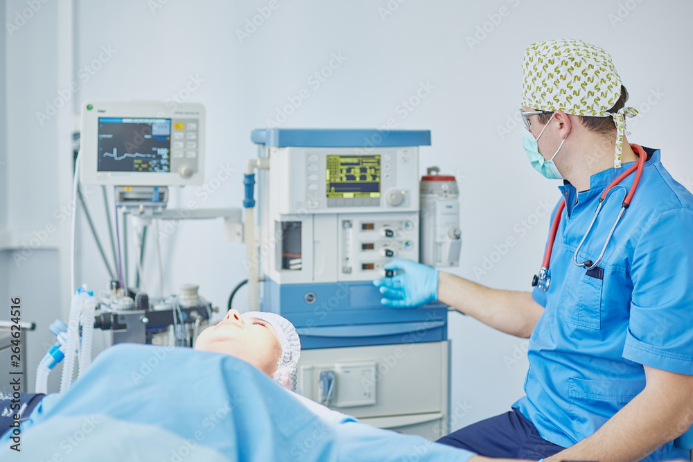 Several doctors surrounding patient on operation table during t Several doctors surrounding patient on operation table during t