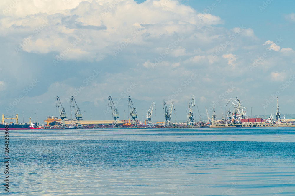 thessaloniki / Greece 11 April 2019 :clouds in the city  the port and the industrial area of the town ,beautiful thermaik gulf in sunny day