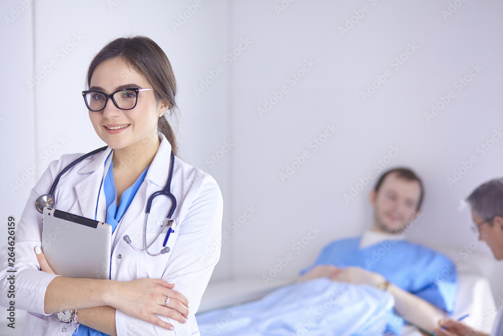 Doctor checking heart beat of patient in bed with stethoscope Doctor checking heart beat of patient in bed with stethoscope